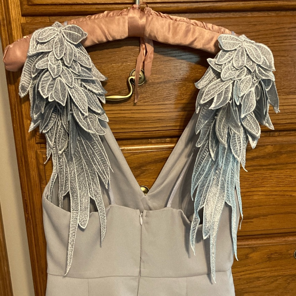 Size small romper, silver-grey. Never worn, brand new. Wings are gorgeous!